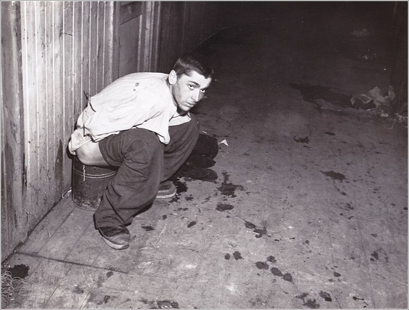 Mauthausen - Photo of an inmate forced to use a makeshift latrine during the operation of the camp